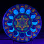 Colorful mandala design under black light on a dark background